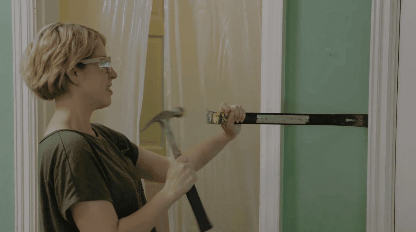 Using Estwing hammer and pry bar to demo an old house