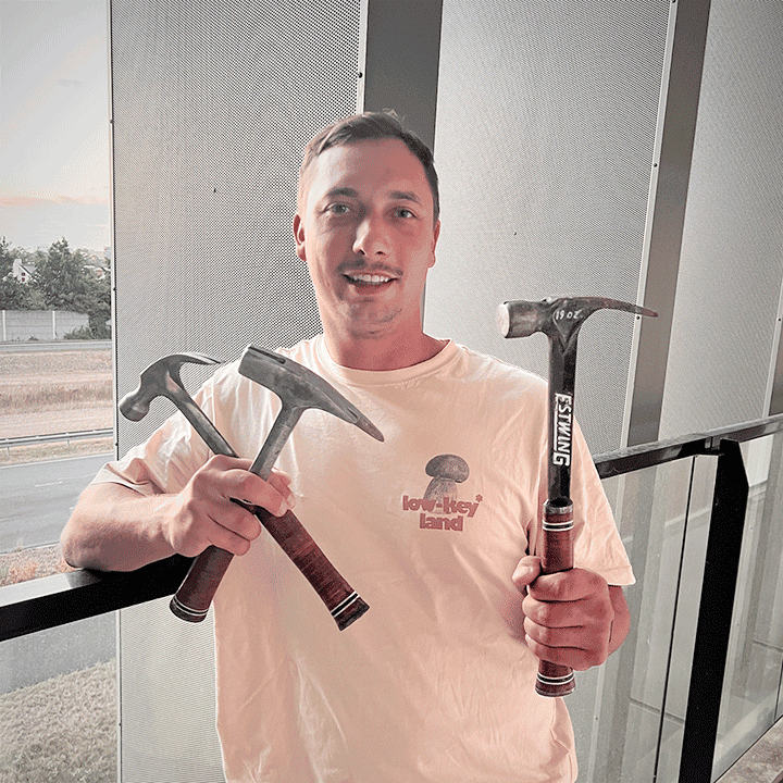 Man showing off collection of Estwing hammers